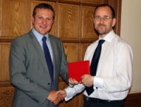 Mat Sutton receiving his prize from Tikit